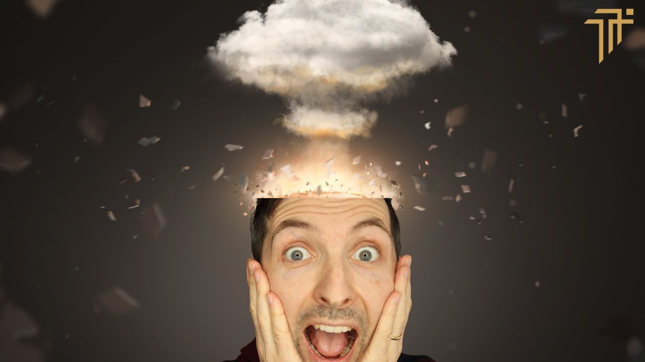 Richard Pryn with a shocked face and hands on cheeks as a mushroom cloud explodes from the top of his head