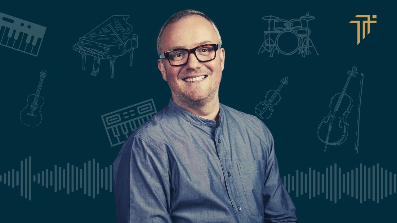 Smiling portrait of composer Christian Henson in front of line drawings of musical instruments