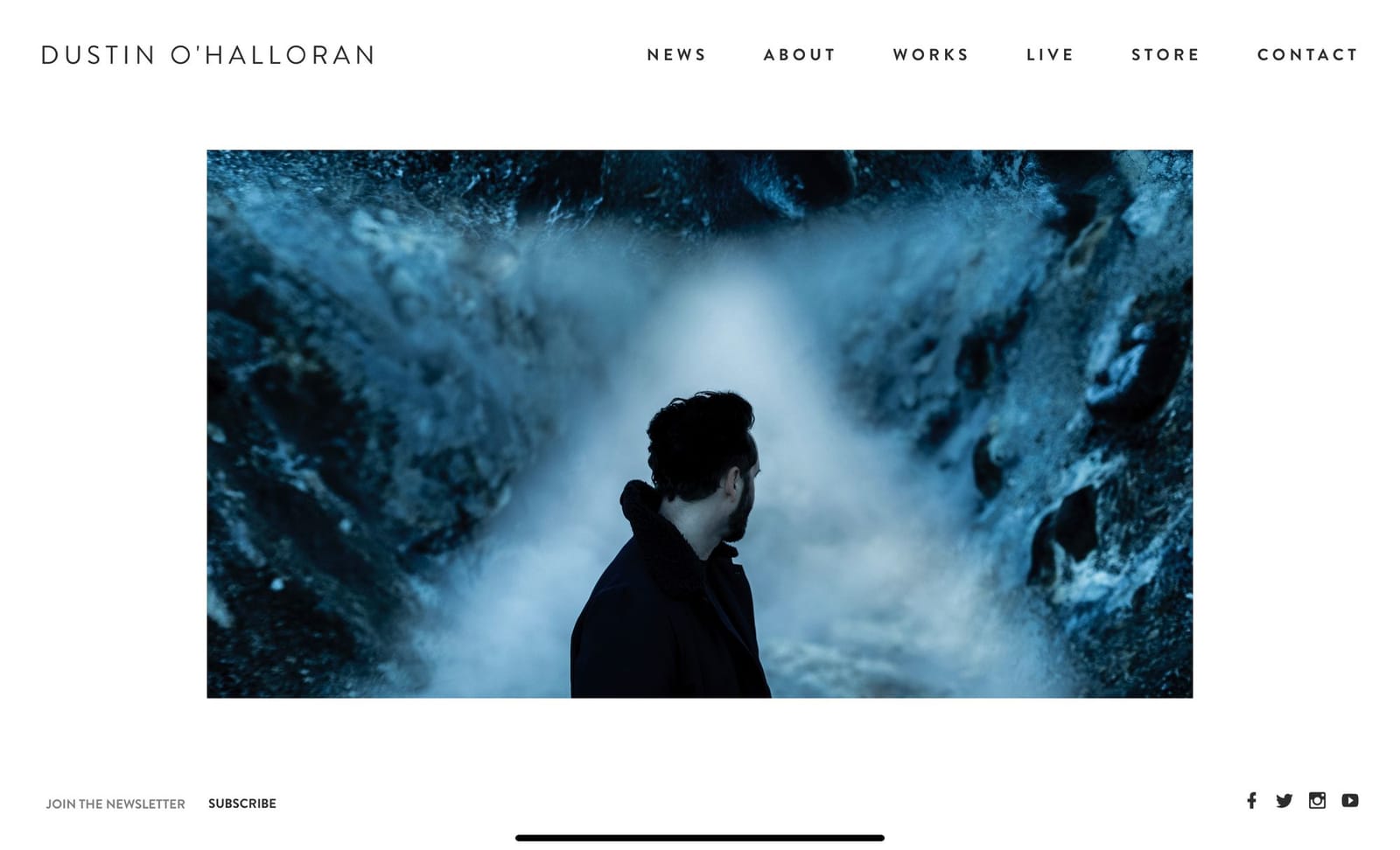 Dustin O'Halloran website homepage with a blue-toned portrait photo