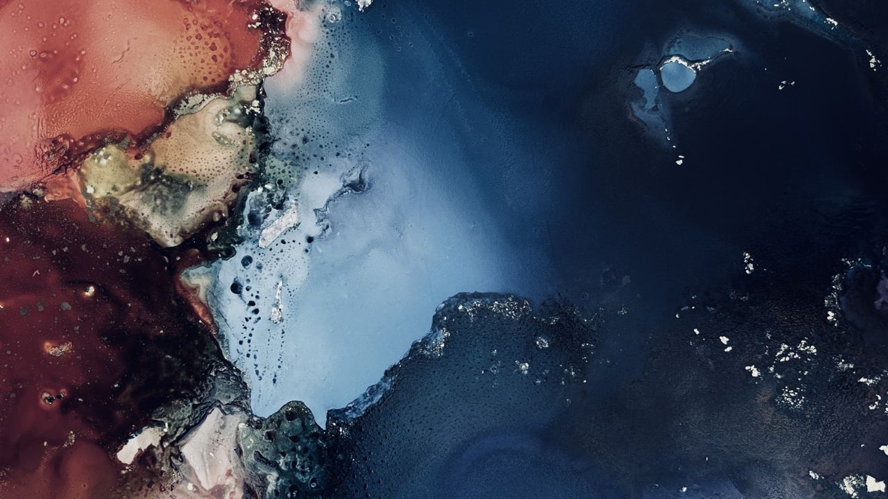 Abstract alcohol ink artwork in deep blue, pale blue and rusty red