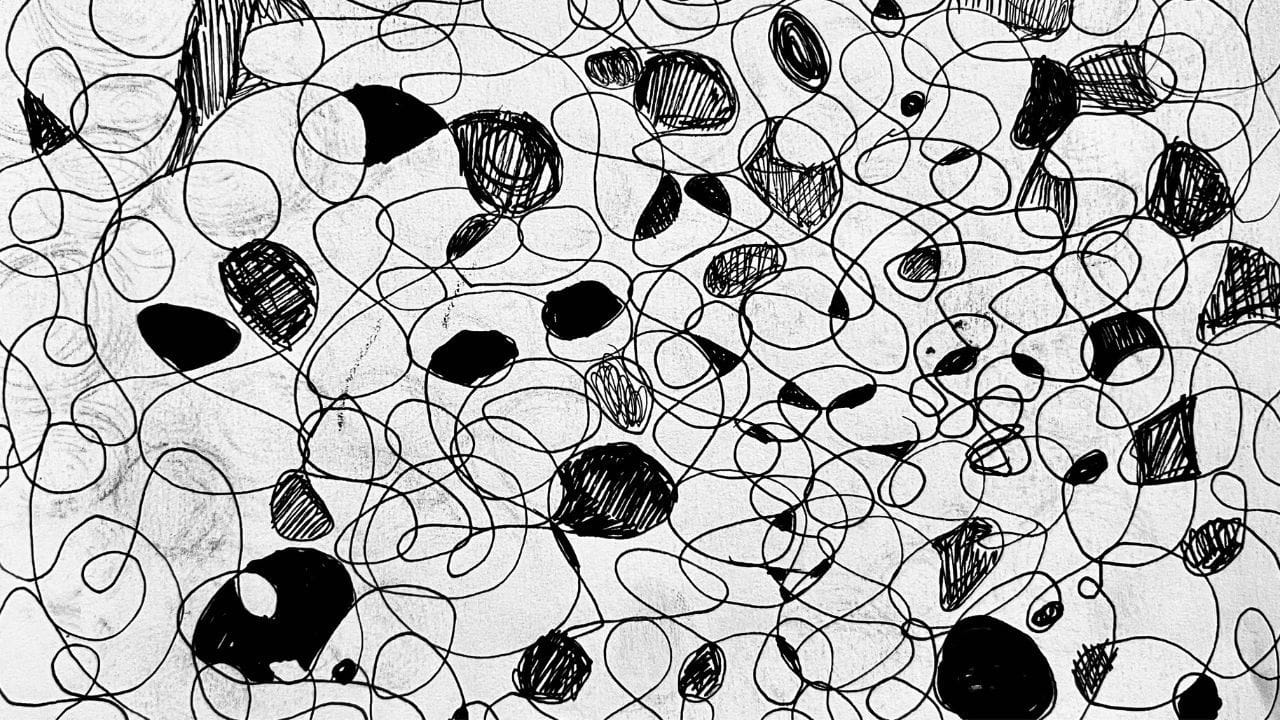 Black ink drawing of looping scribbles and shaded shapes on white paper